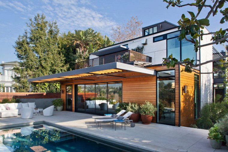 The Adelaide Midcentury Modern House is one of Ray Kappe’s prefab Livinghomes that’s made up of 11 modules installed on a beautiful lot in Santa Monica over the course of just two days. With a focus on indoor/outdoor living, the design is split over multiple levels that help define certain areas while remaining open and light. Complementing the home’s style are the warm, modern interiors that were designed by DKD LTD.